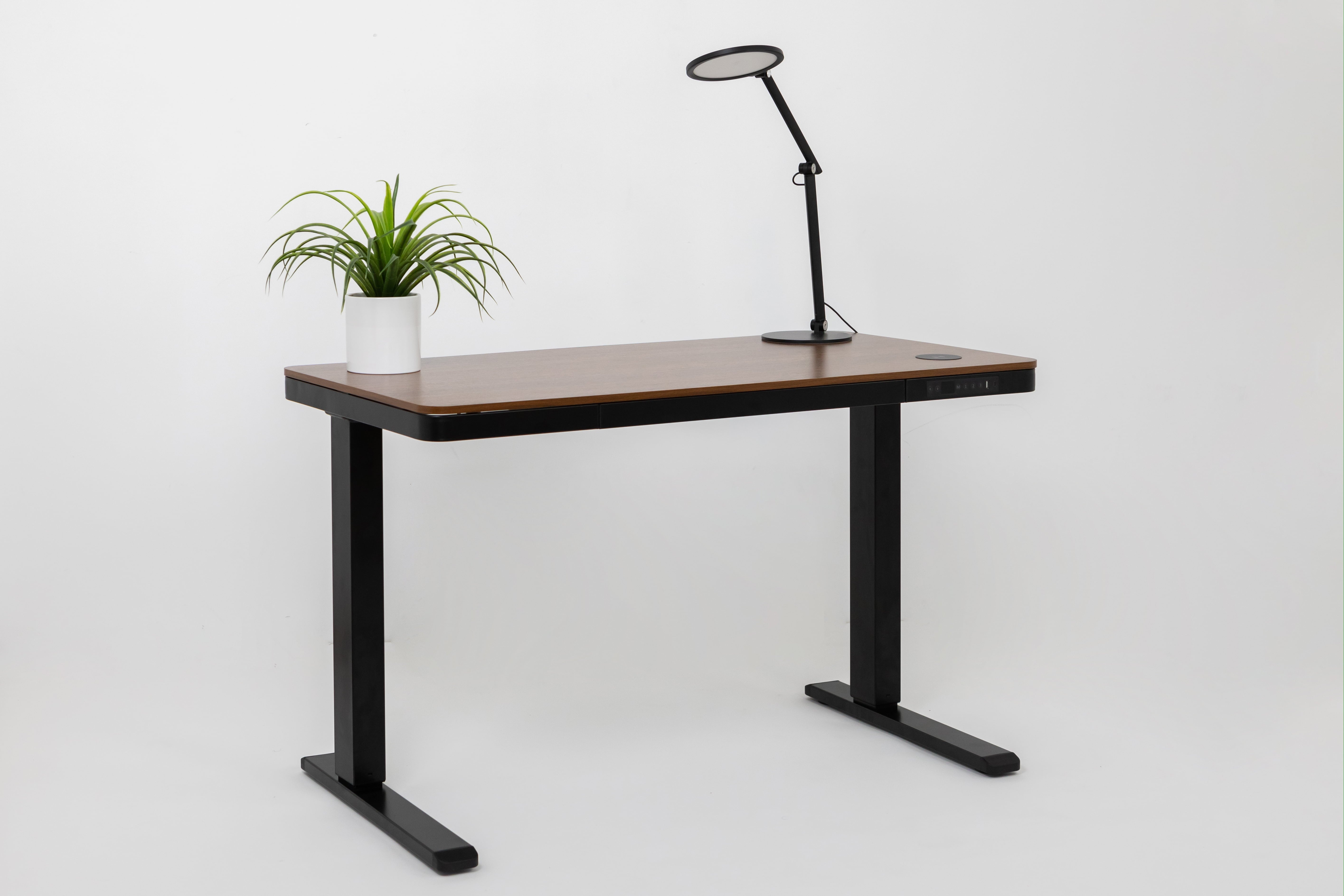 Modern black electric height-adjustable desk with warm walnut wood top and charging port by purus life