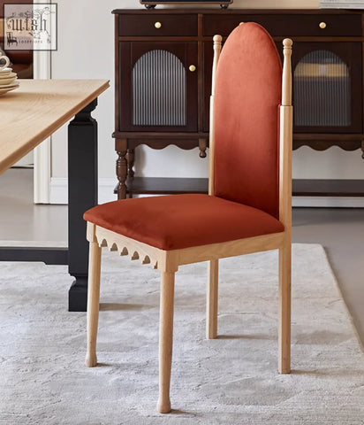 A modern ealing high-back dining chair with a light wood frame and terracotta velvet seat and backrest upholstery