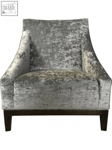 Silver-gray distressed velvet ease arm chair with dark wood legs perfect for cozy living spaces