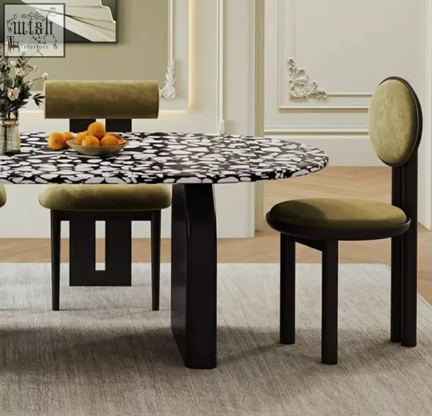 Modern eaton black dining table with oval black and white terrazzo top and dark matte legs paired with olive chairs
