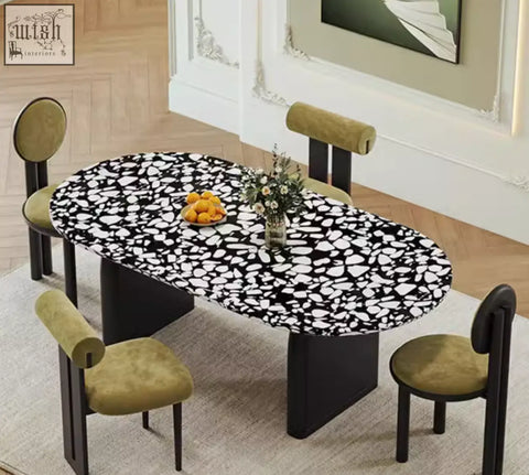 Eaton black dining table with black terrazzo speckled oval top and sleek black pedestal legs for dining room use