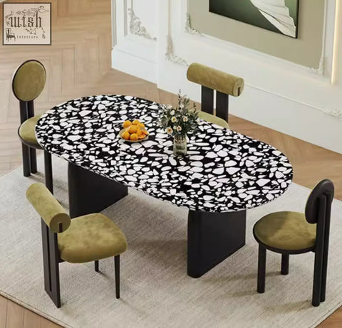 Eaton dining table with black terrazzo speckled oval top and sleek black pedestal legs perfect as a dining table