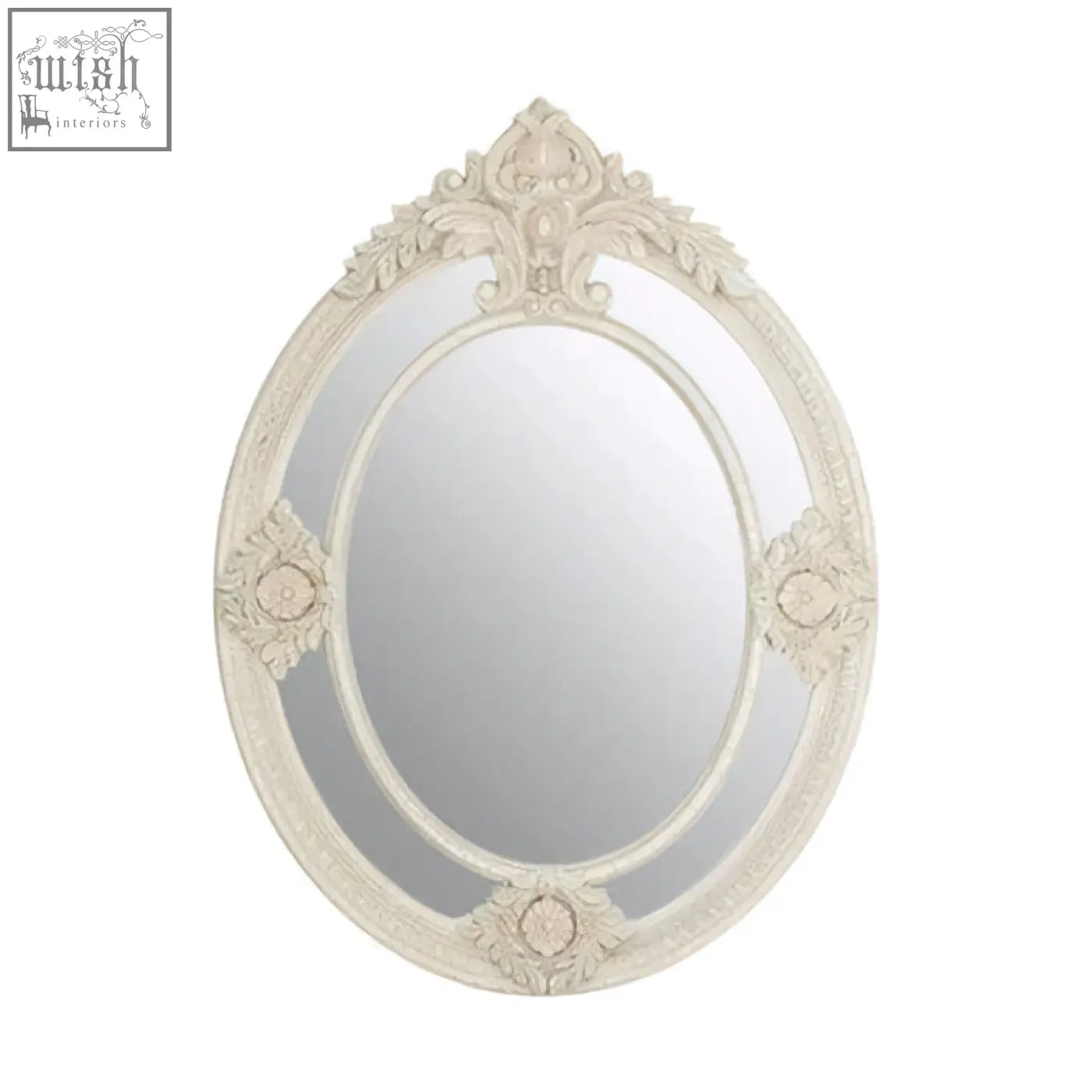 An ornate oval eclipse antique white mirror with a distressed frame and intricate floral scrollwork design