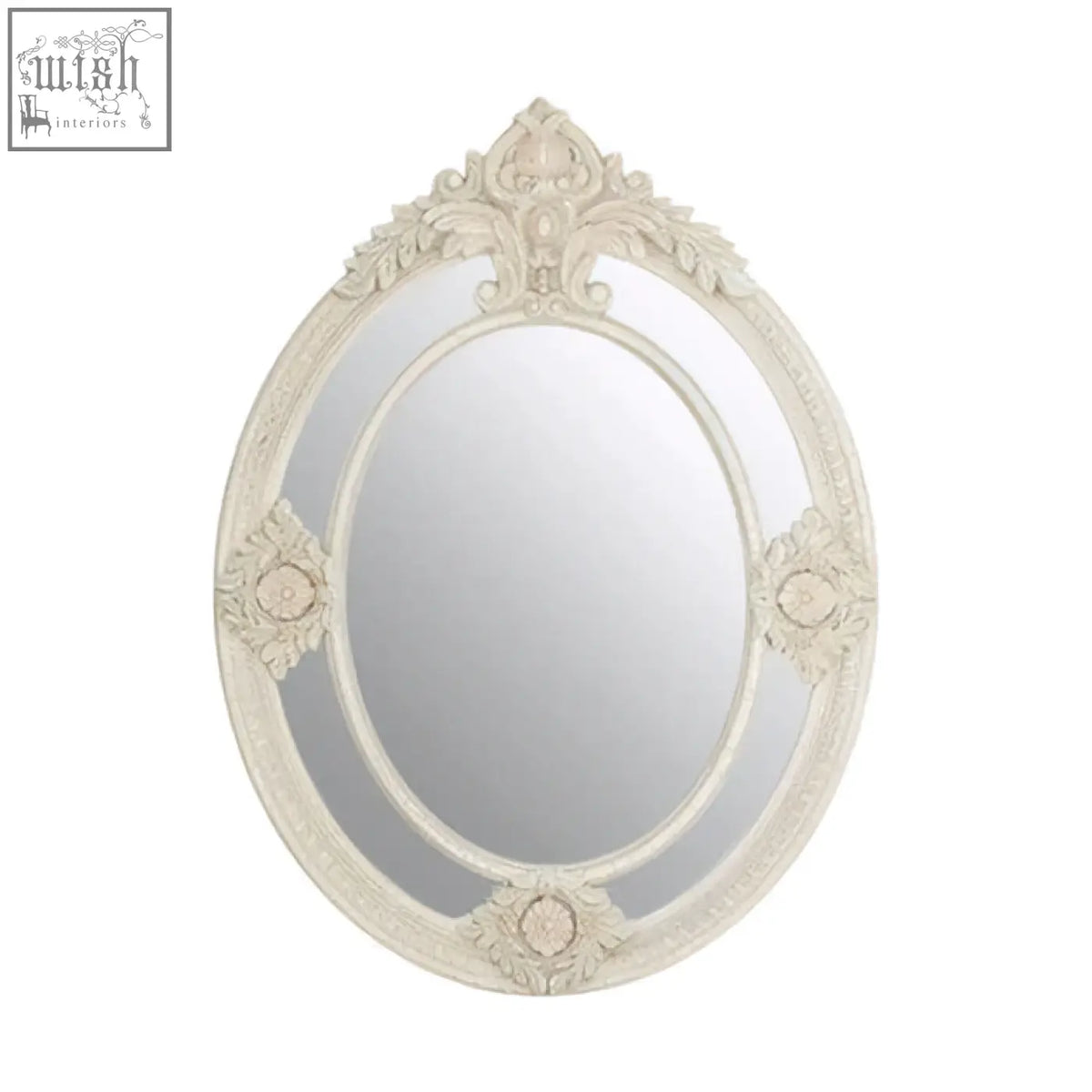 An ornate oval eclipse antique white mirror with a distressed frame and intricate floral scrollwork design