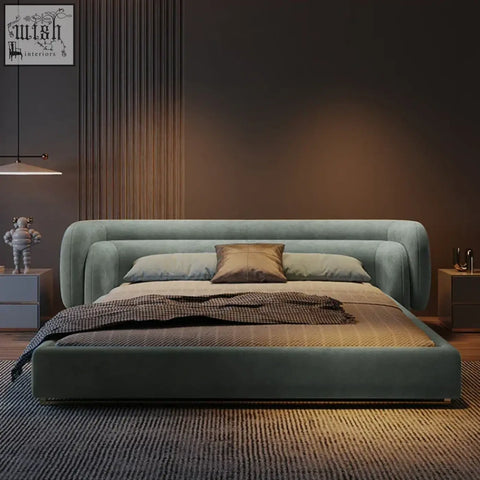 A sleek eclipse bed with plush teal velvet upholstery and a rounded frame for a modern bedroom look