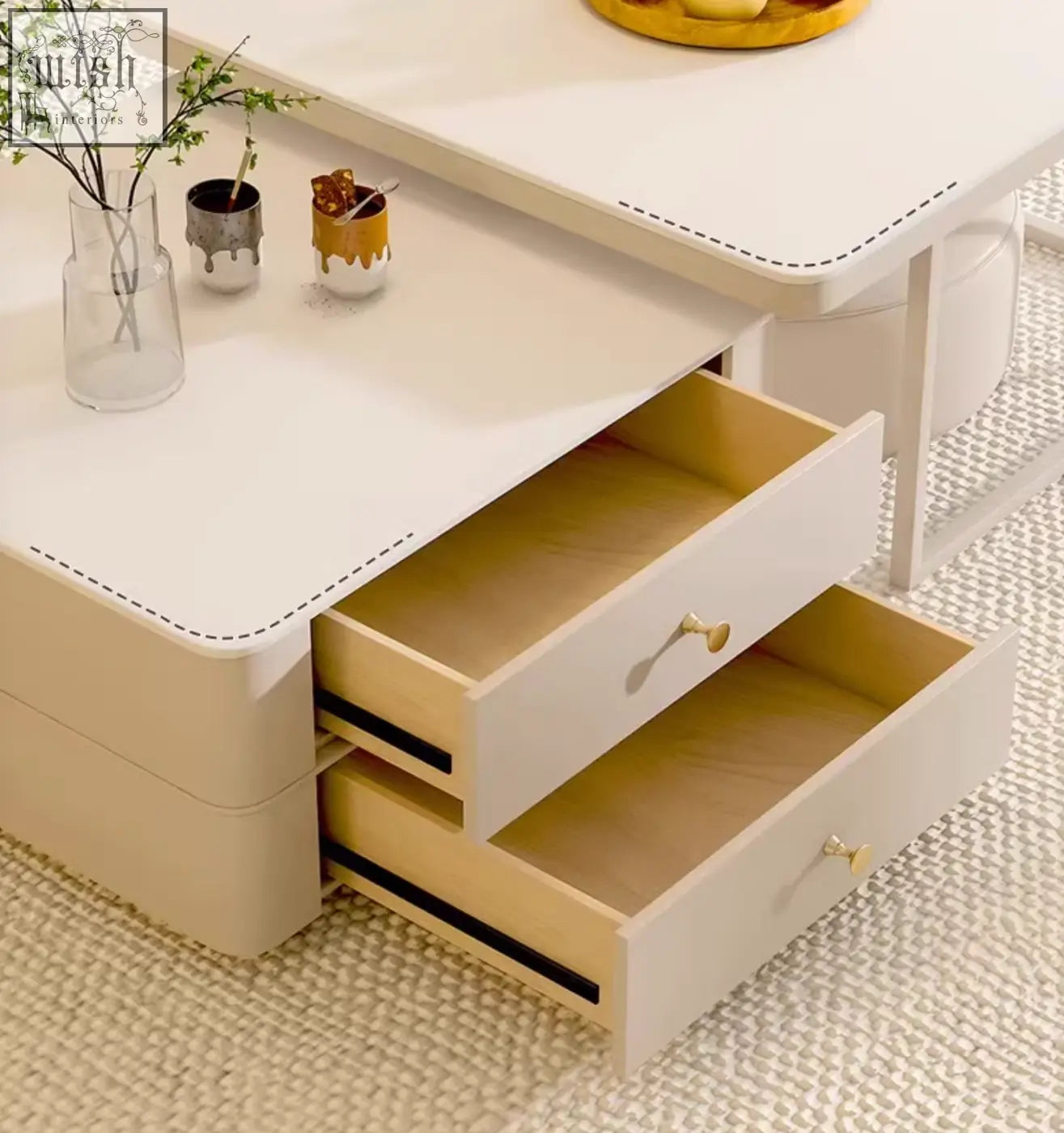 Beige eclipse nesting coffee table with two open drawers, light wood interiors, and gold-tone handles in cream set