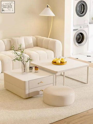 Cream-colored modular sofa with tufted cushions paired with eclipse nesting coffee table set and matching ottoman