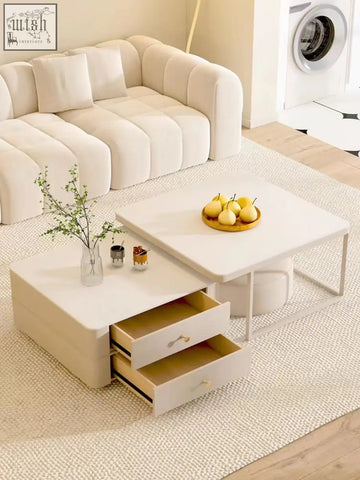 Modern white eclipse nesting coffee table with two open drawers and sleek metal frame in cream finish