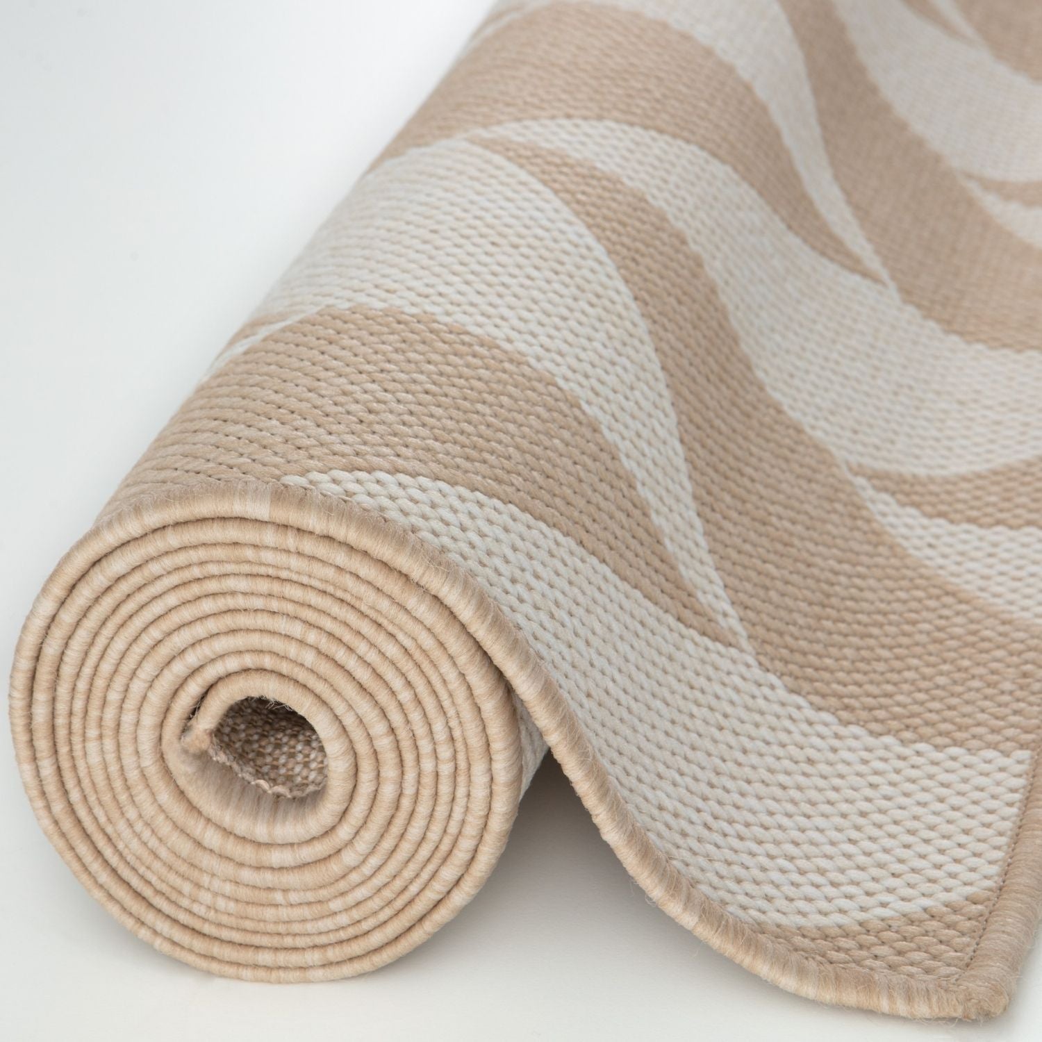 Rolled beige and cream wavy-patterned ecology outdoor rug with textured woven fabric perfect for outdoor use