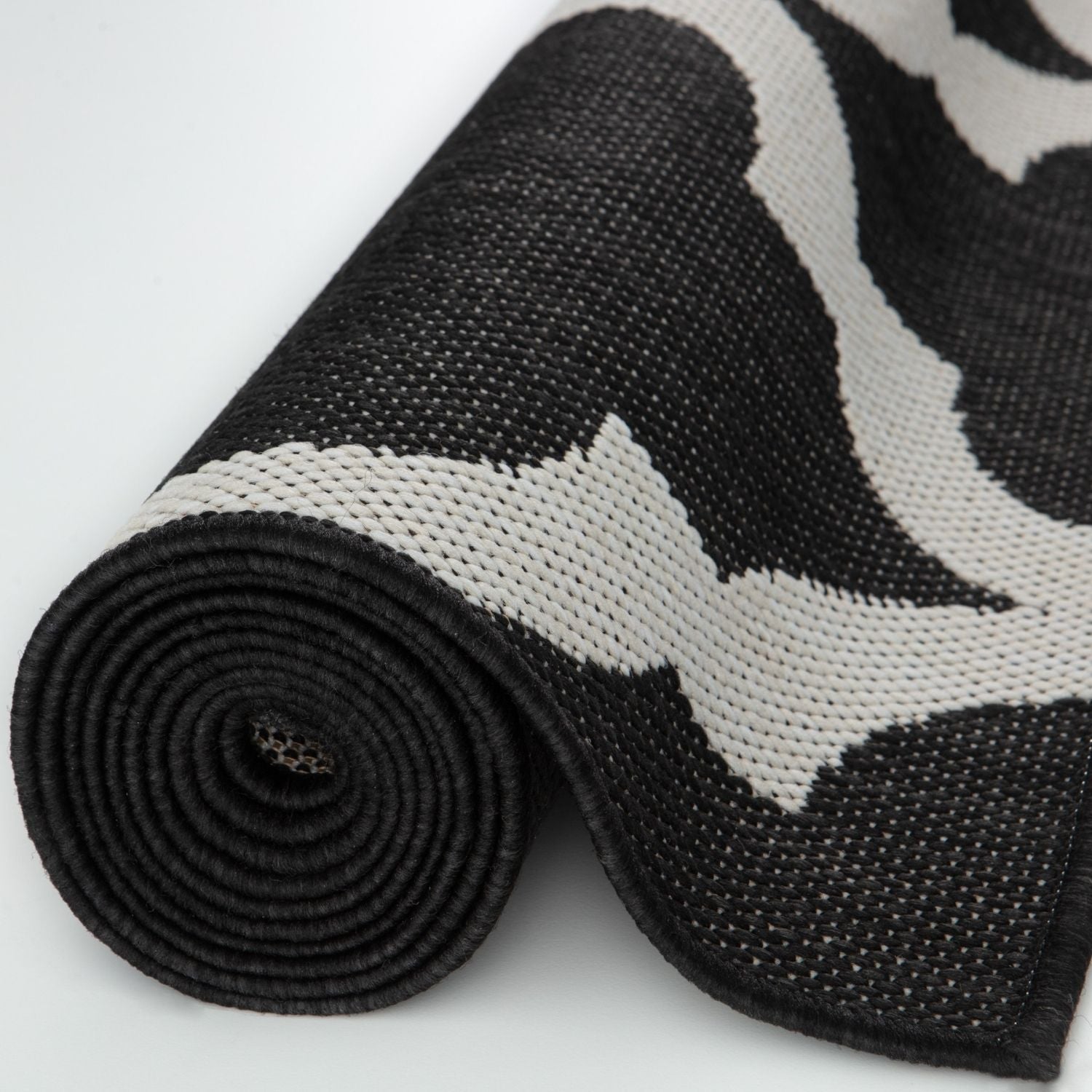 Black and white woven ecology outdoor rug with bold abstract wave pattern perfect as outdoor rug black style