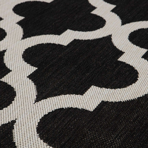 Black and white woven ecology outdoor rug with repeating quatrefoil pattern perfect for outdoor rug black use
