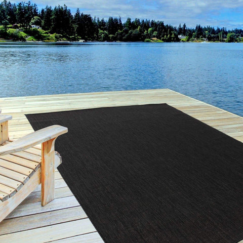 Black textured ecology outdoor rug on wooden dock perfect for outdoor rug black use