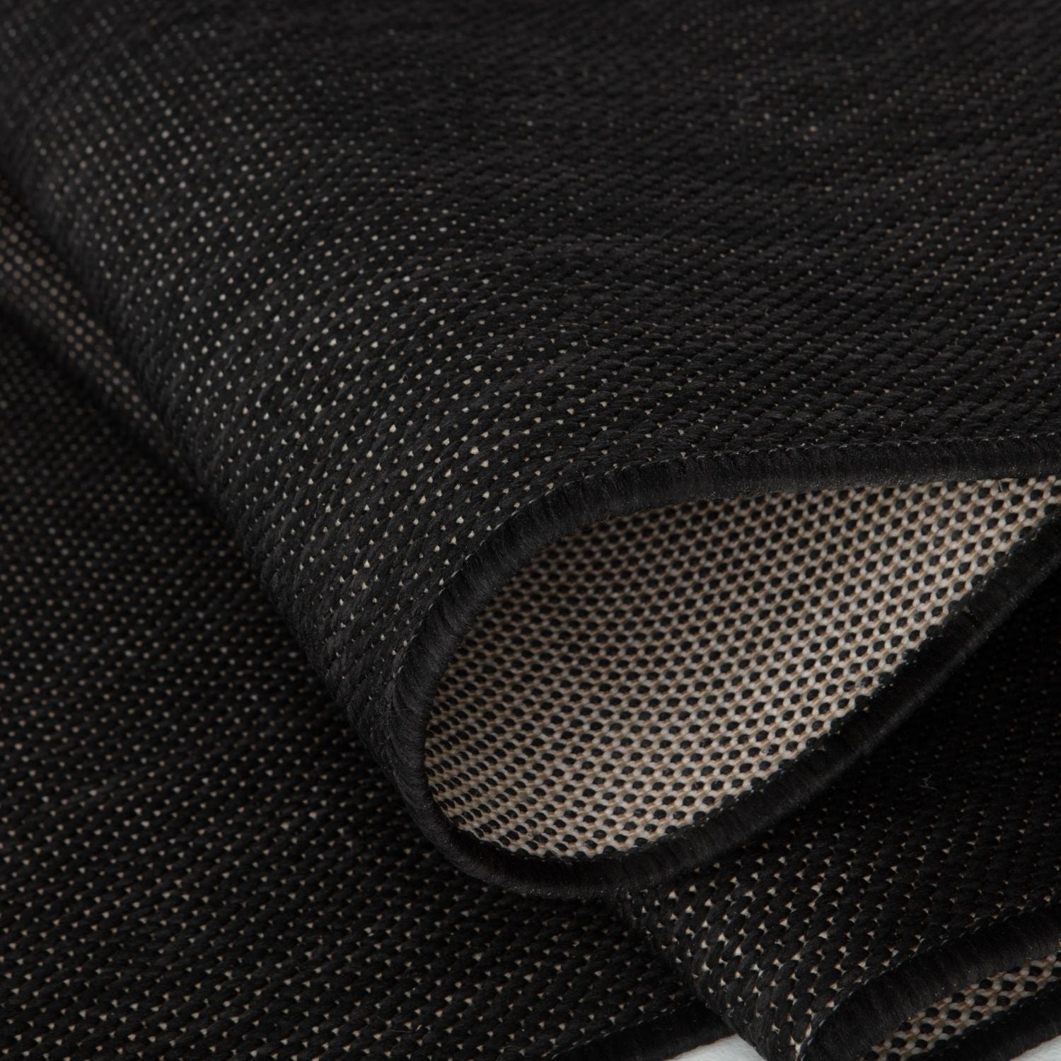 Black woven mesh ecology outdoor rug with textured breathable surface and reinforced edges outdoor rug black