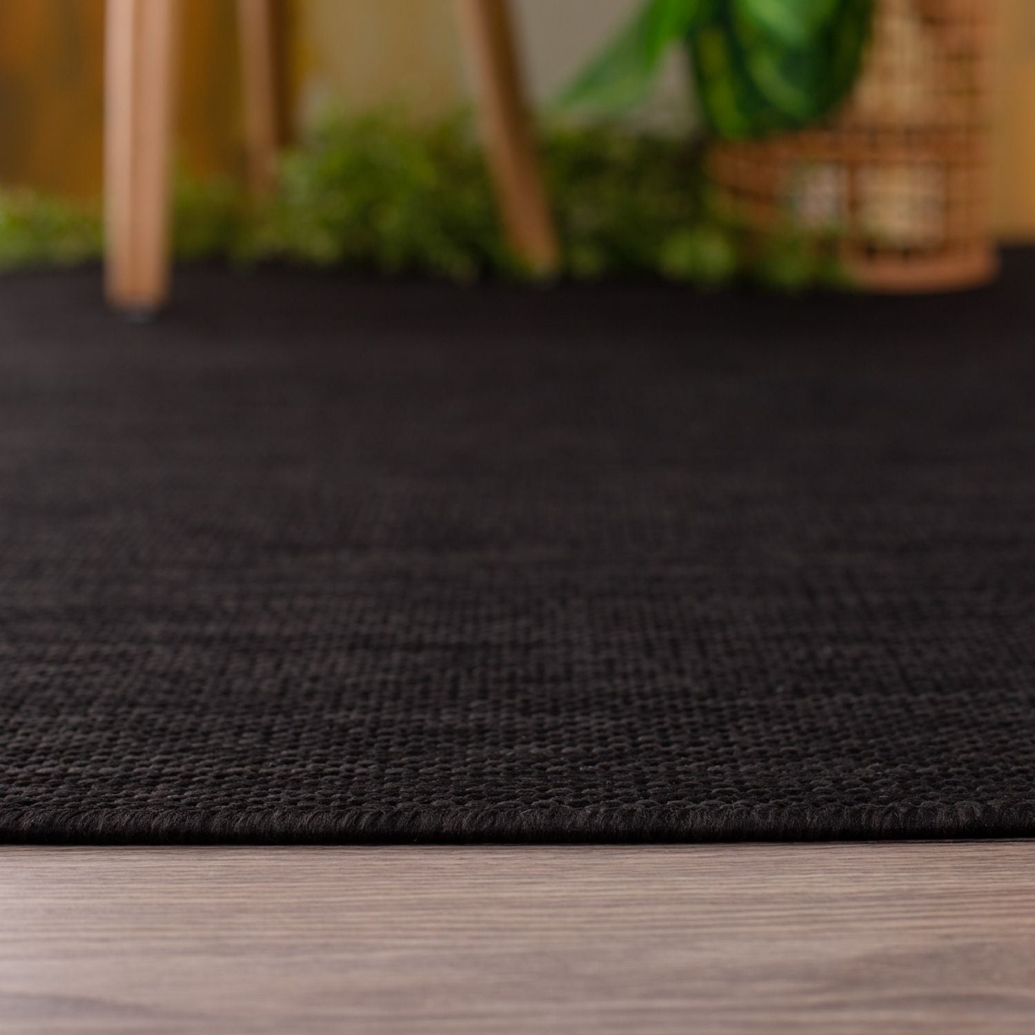 Ecology outdoor rug black with a tightly woven textured pattern perfect for outdoor use
