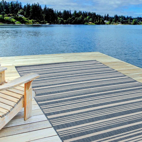 Ecology outdoor rug blue featuring durable woven material with dark gray and beige striped pattern for outdoor use
