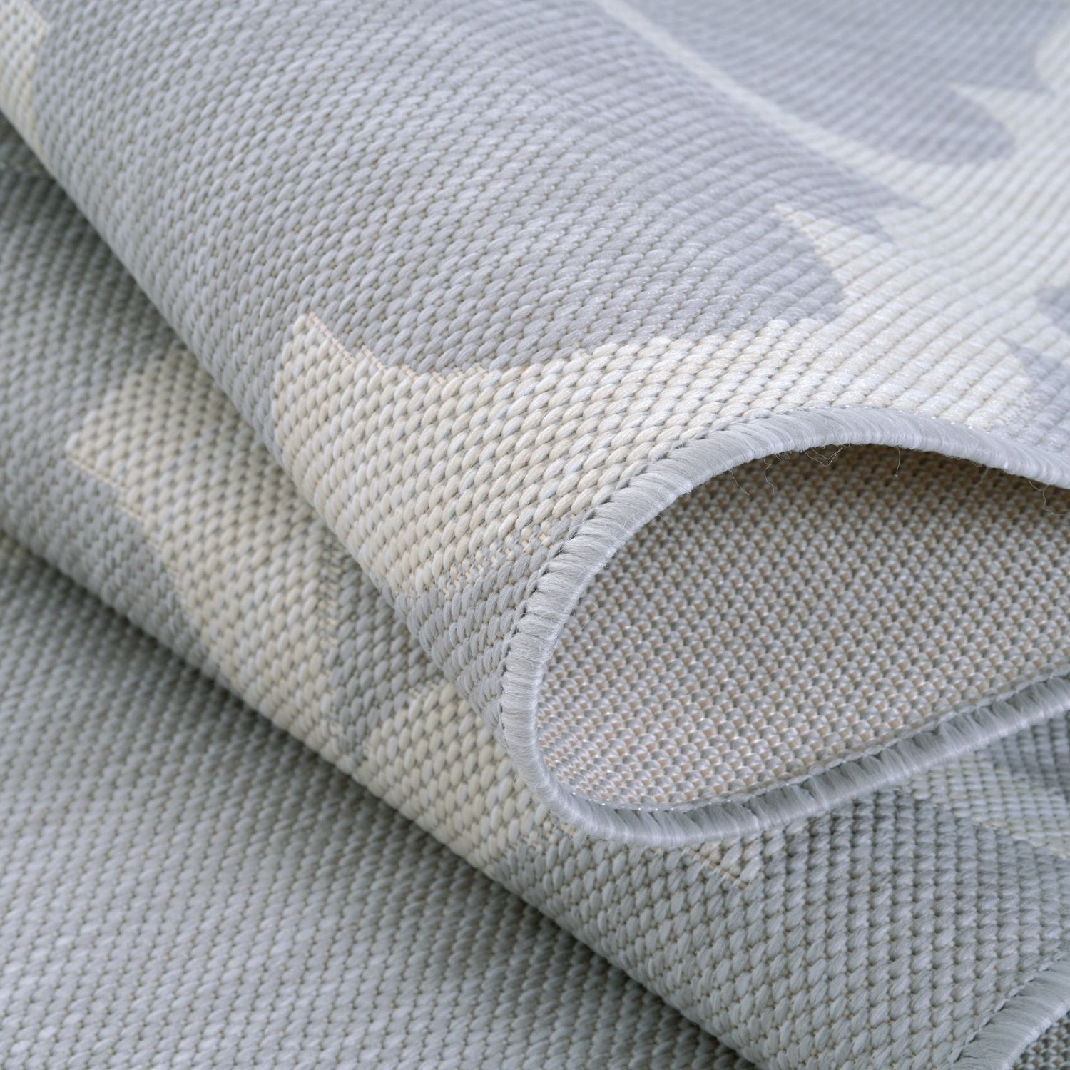 A soft gray woven ecology outdoor rug with subtle texture and neat edges perfect for outdoor use outdoor rug grey