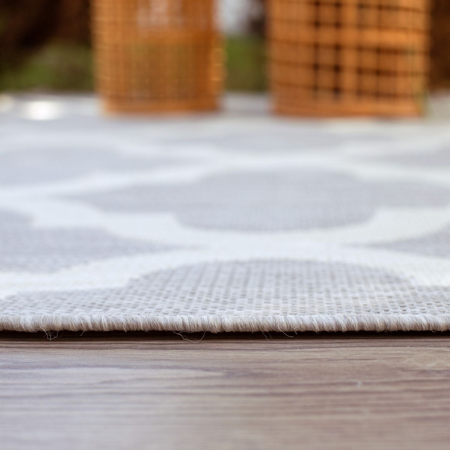 A white and gray geometric patterned ecology outdoor rug grey with a textured woven edge perfect for outdoor use