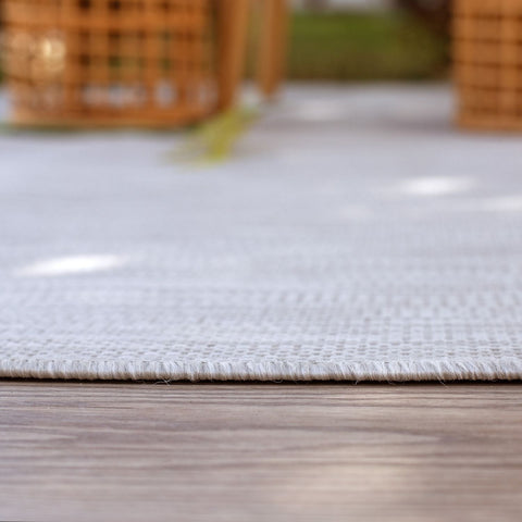 Light gray woven ecology outdoor rug with textured frayed edges on wooden floor perfect outdoor rug grey option