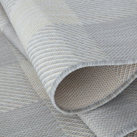 A light gray ecology outdoor rug with a textured herringbone pattern and neatly finished edges perfect for outdoor use