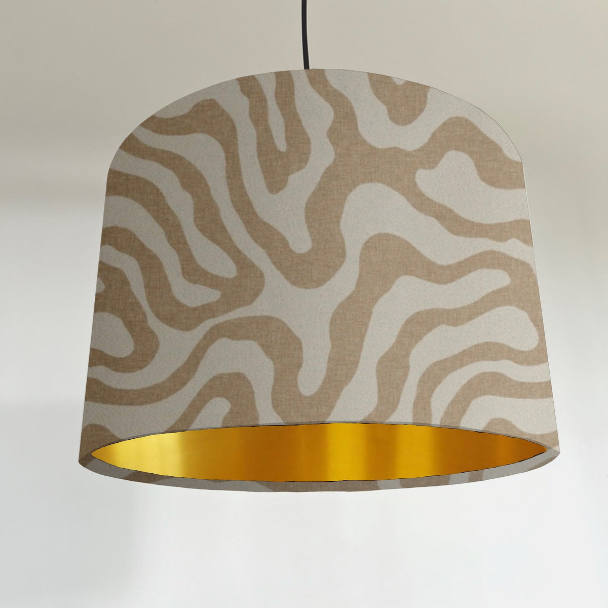 Beige and white ecru wiggle drum lampshade with abstract pattern and metallic brushed gold lining inside
