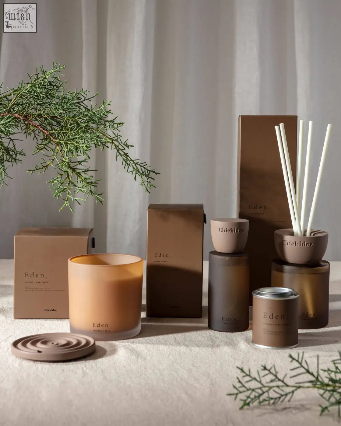 A matte brown clay home spray diffuser with white reed sticks from eden clay home for a fresh scent