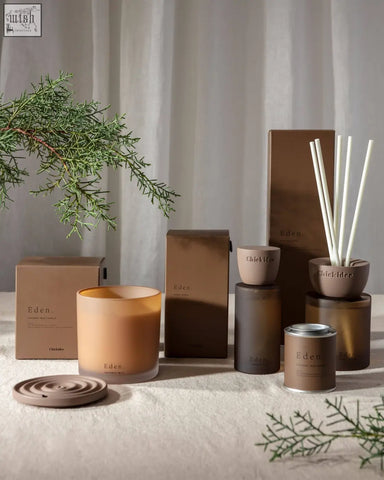 A matte brown clay home spray diffuser with white reed sticks from eden clay home for a fresh scent