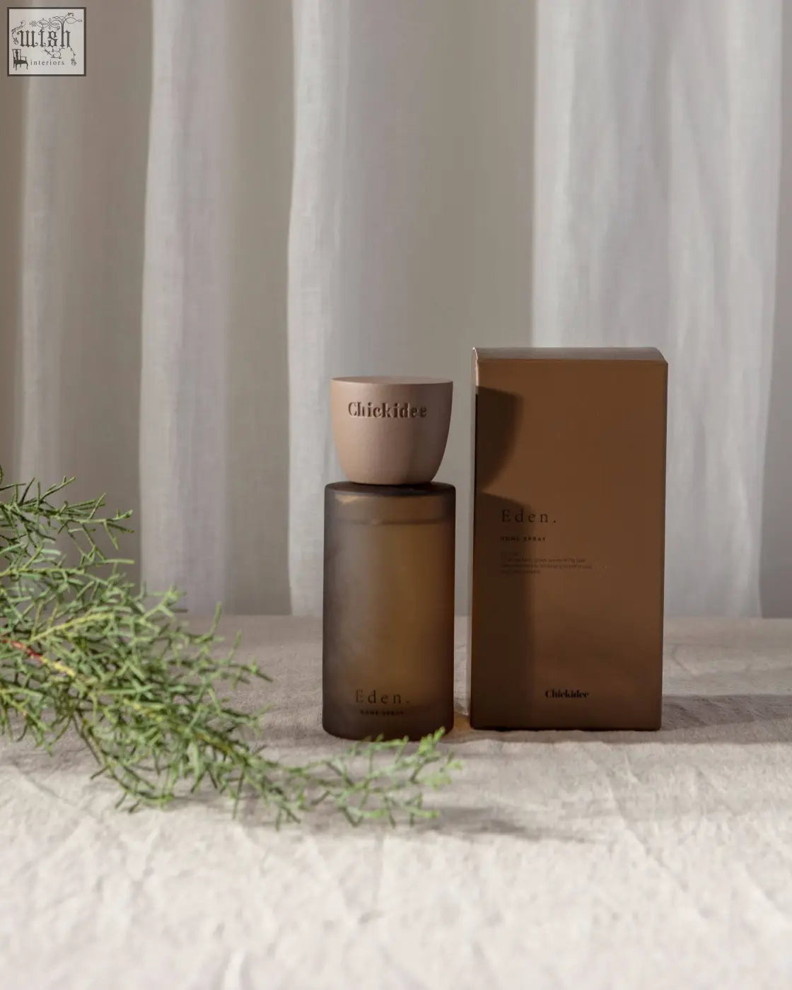 A sleek matte brown glass bottle with matching cap and minimalist branding for eden clay home spray