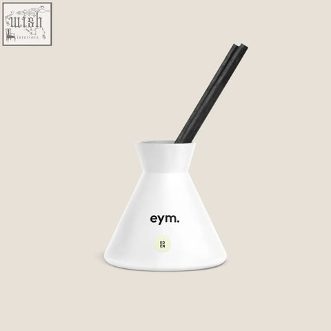 White ceramic diffuser holder with black reed sticks and eym branding from eden diffuser collection