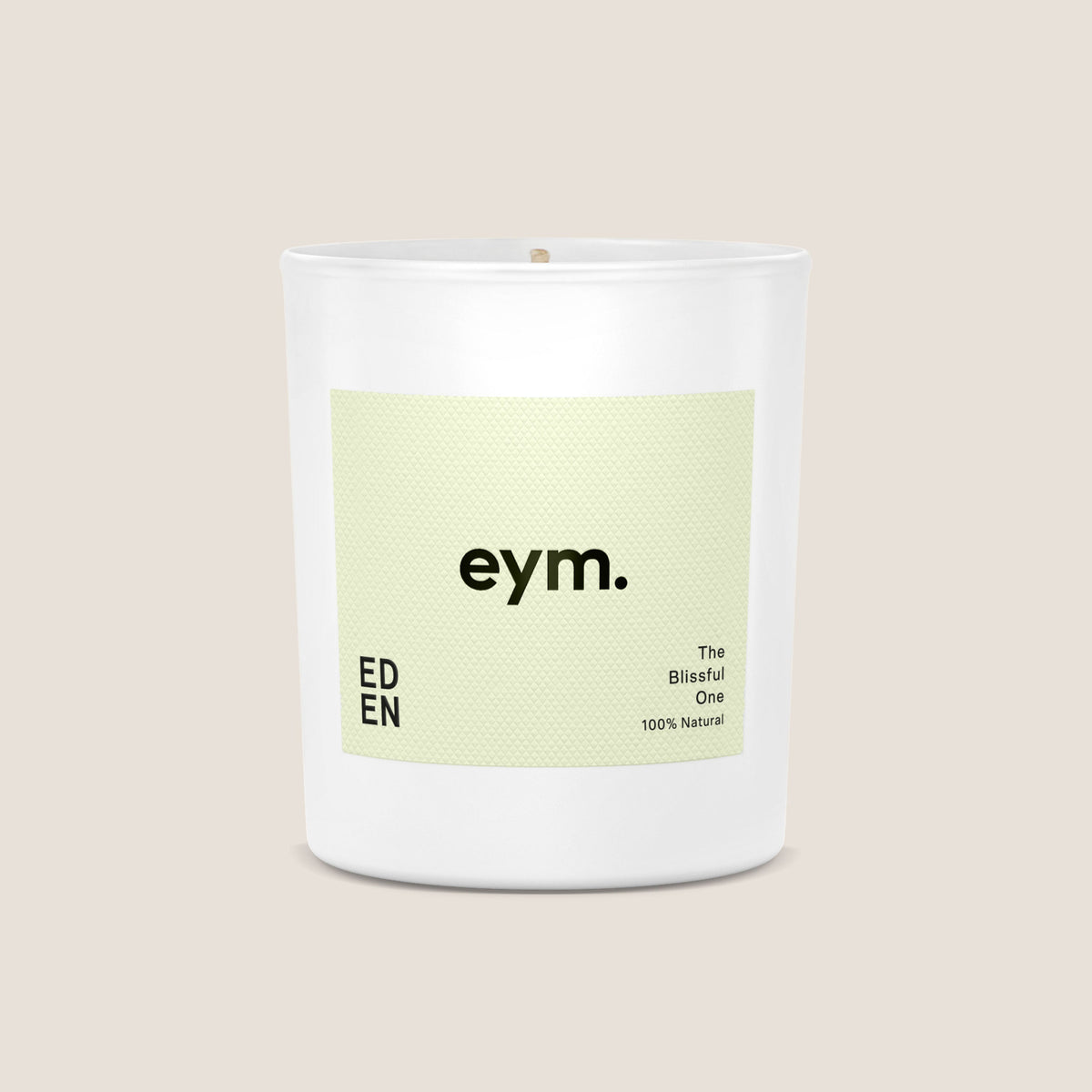 A minimalist white glass standard candle jar with a pale green eym label the blissful one 100 percent natural