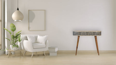 A sleek edessa bone inlay console table with black and white geometric top and slender mango wood legs