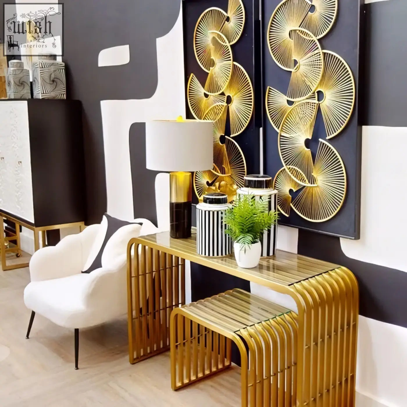 Gold-toned console table with vertical slats and reflective surface paired with edgar black marble gold table lamp