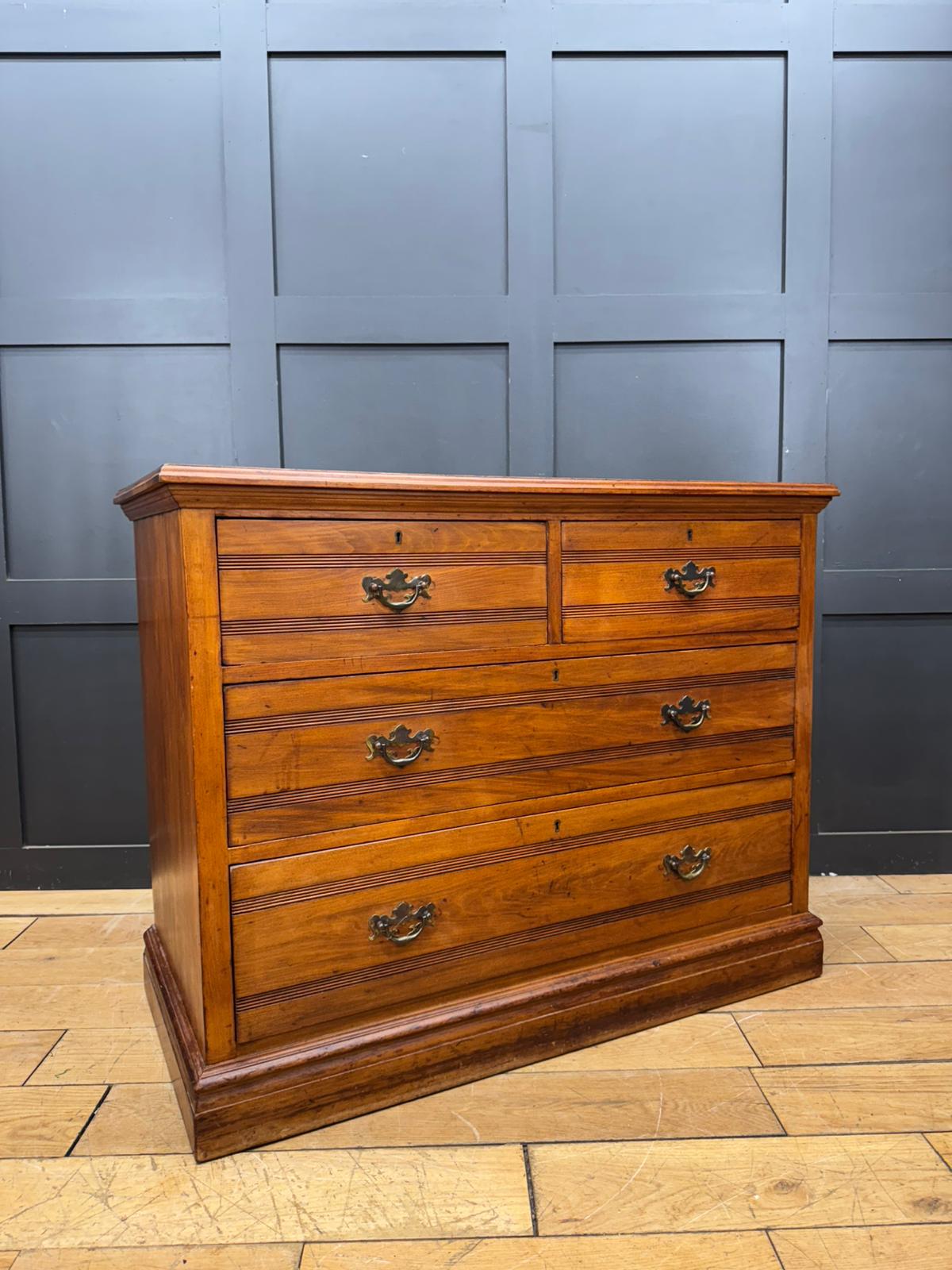 Antique edwardian walnut chest of drawers with five drawers brass handles and subtle wood grain detailing