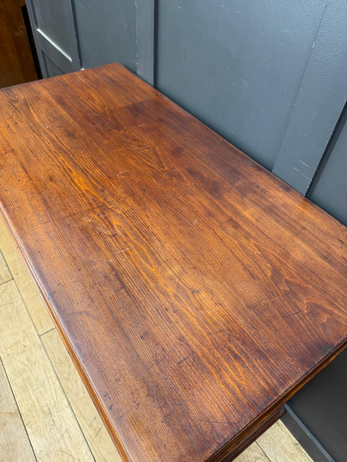 A polished edwardian walnut chest with richly stained wood and visible grain patterns for bedroom storage