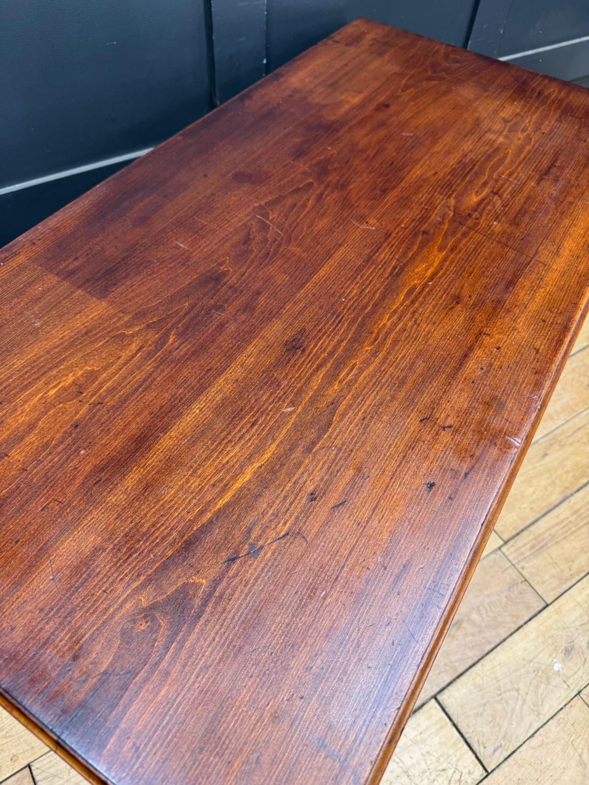 Rich warm-toned rich edwardian walnut chest wooden table with polished finish and visible grain patterns