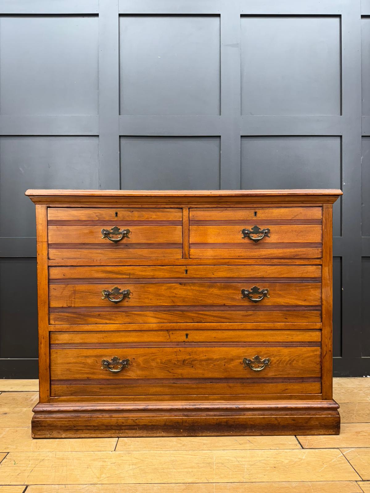 Antique edwardian walnut chest of drawers with five drawers dark brown finish and ornate black metal handles