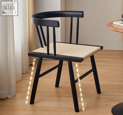 Eenoch dining chair with black wooden frame and woven beige rattan seat perfect for dining areas