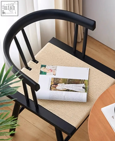 Black wooden eenoch dining chair with woven beige rattan seat cushion for stylish dining use