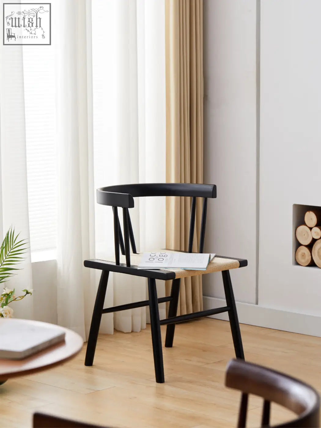 Black eenoch dining chair with woven rattan seat and curved backrest for stylish dining room seating