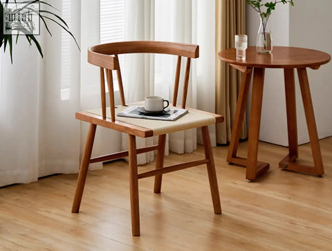 Eenoch dining chair with curved wooden backrest and woven rattan seat in natural tones perfect for dining spaces