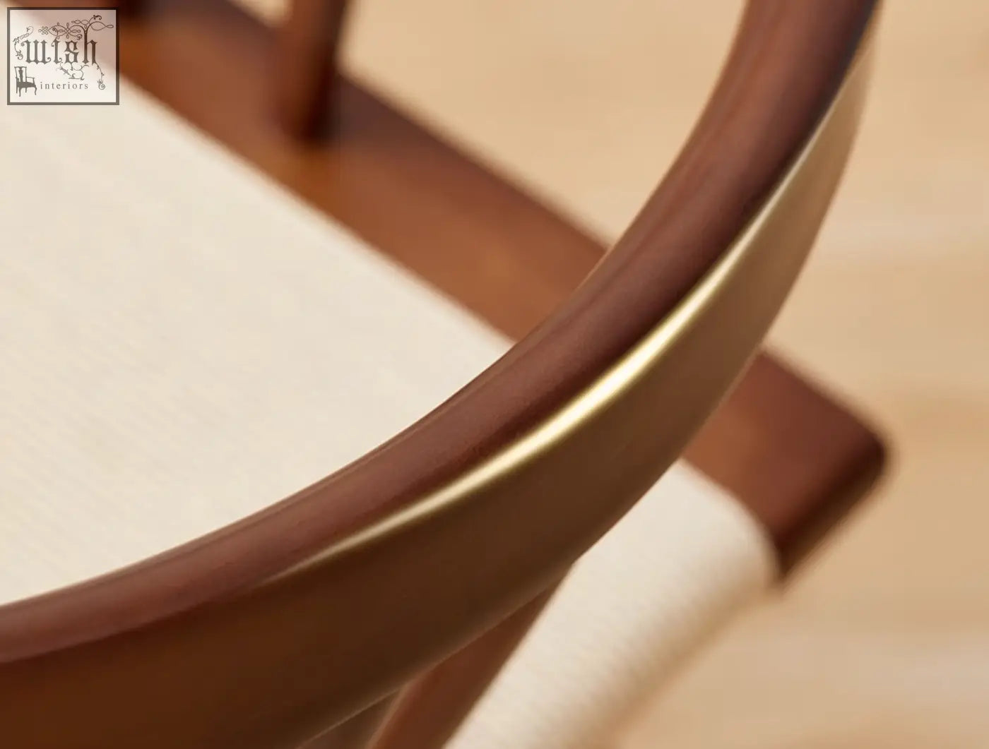 A sleek eenoch dining chair frame with curved warm brown wood and subtle gold trim for stylish dining seating