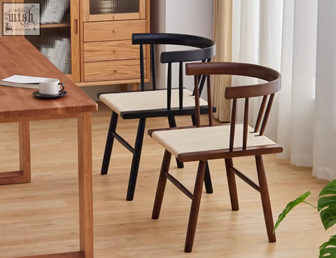 Two eenoch dining chairs with curved wooden frames in dark brown and black and woven beige rattan seats