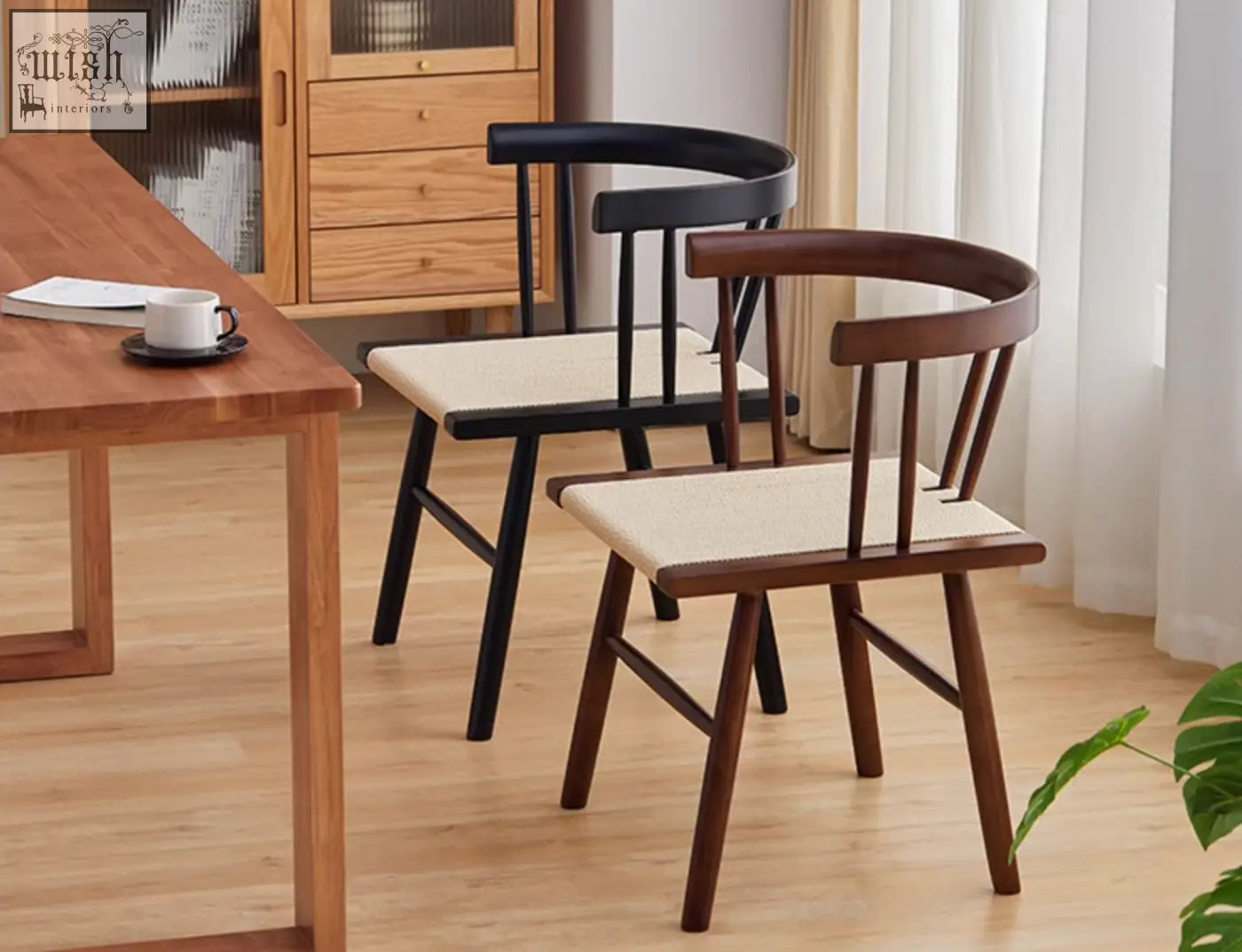 Two eenoch dining chairs with curved wooden frames in dark brown and black and woven beige rattan seats
