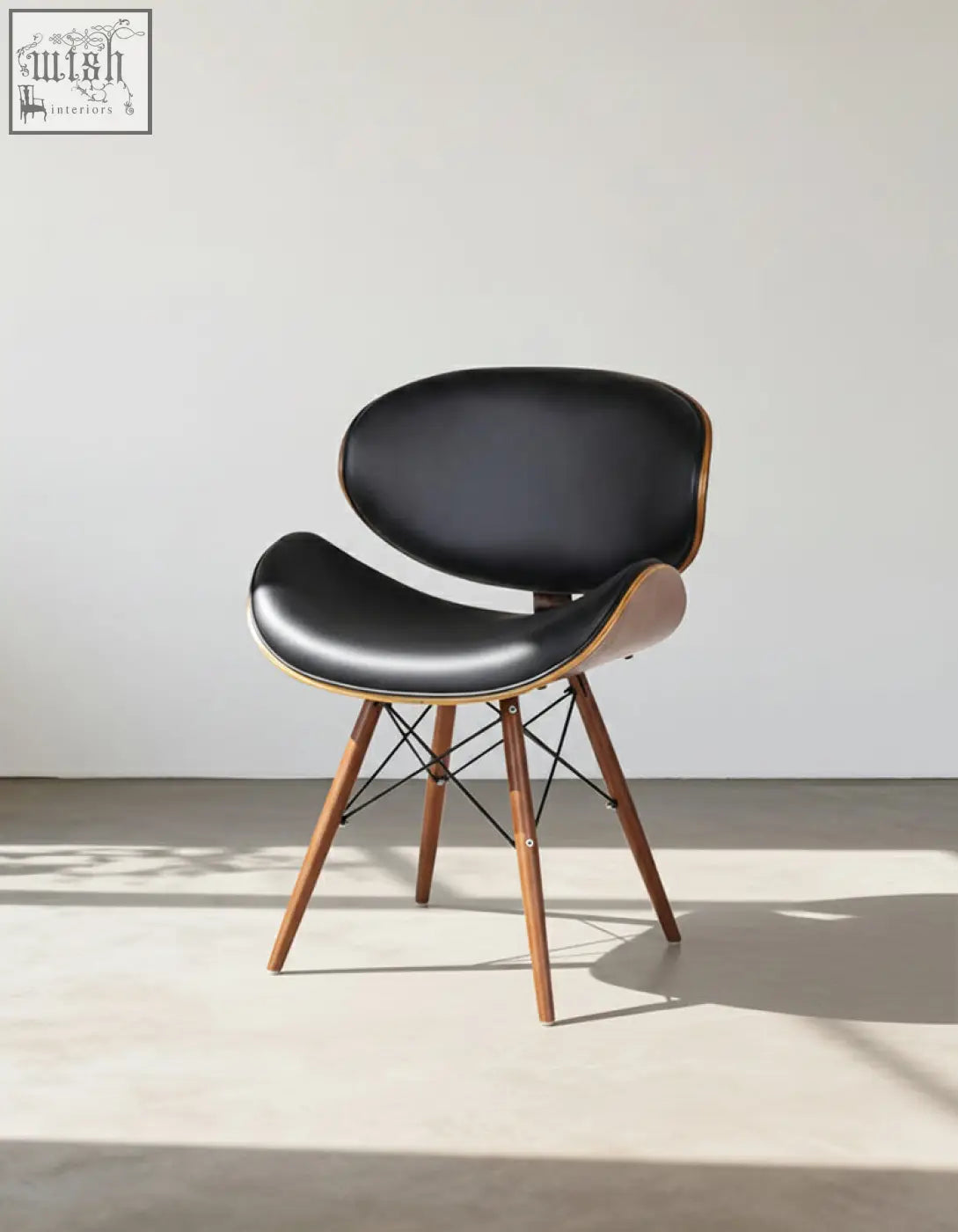 Black leather eiffel dining chair with curved walnut frame and tapered legs easy to clean with a damp cloth