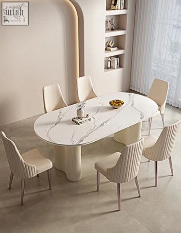 Modern oval dining table with white marble top and cream sculpted pedestal legs paired with offer financing dining chair
