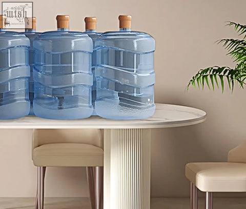 Clear blue plastic water jugs with wooden caps arranged on a white dining table eira white dining table oval