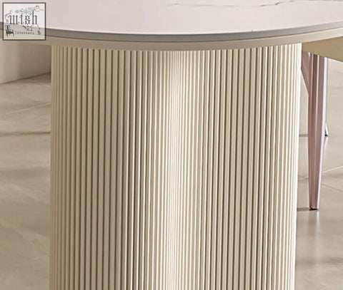 Eira white dining table with a smooth white top and cream ribbed base perfect for stylish white dining spaces