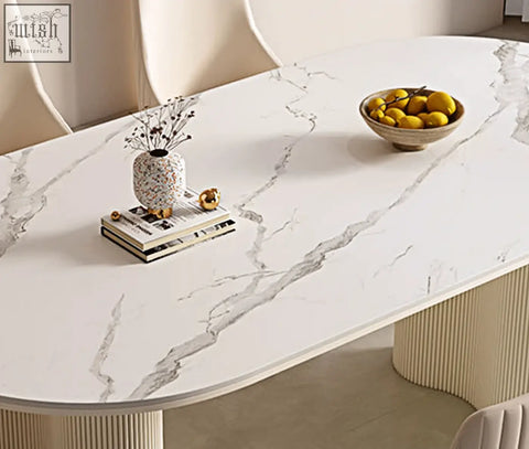 Eira white dining table with oval white marble effect top and ribbed cream legs perfect for white dining spaces