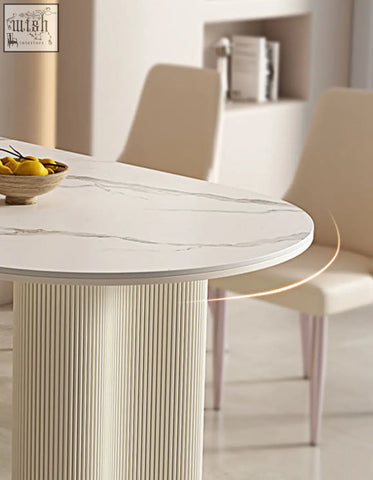 Eira white dining table with oval white marble effect top and sleek ribbed pedestal base perfect for white dining spaces