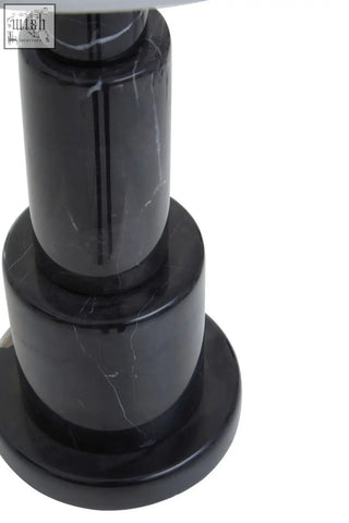 Elara black marble table lamp with ivory shade featuring a sleek black marble base with tiered cylindrical sections and white veining