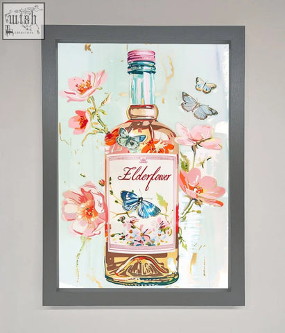 A framed elderflower wine artwork featuring a pink and gold gin bottle with pink flowers and butterflies wall art